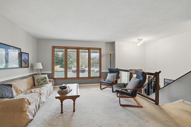 carpeted living area with baseboards