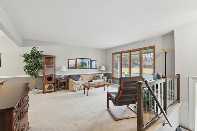 living area featuring light carpet
