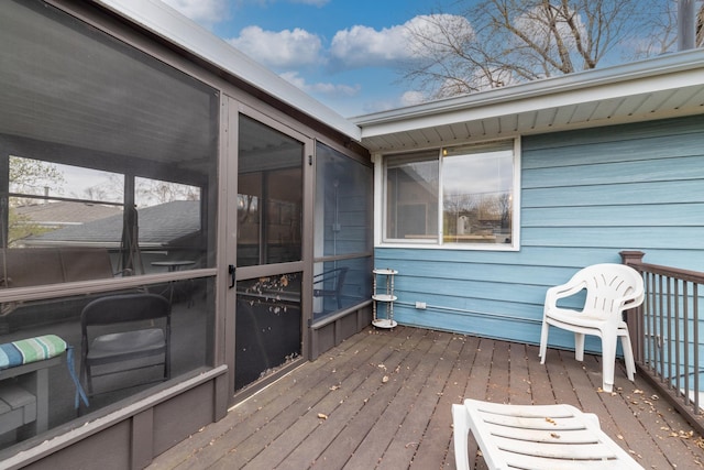 wooden deck with a sunroom