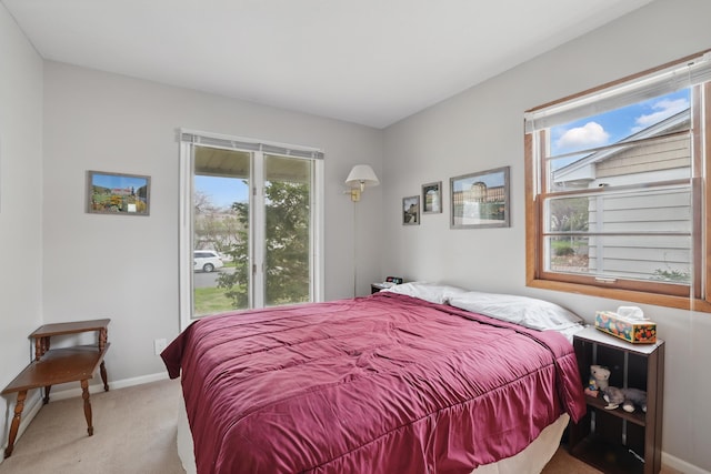 bedroom featuring baseboards and light carpet