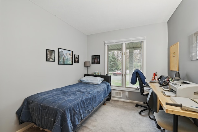 bedroom with baseboards, light colored carpet, and visible vents