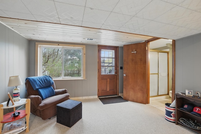 living area with visible vents, carpet flooring, and a wealth of natural light