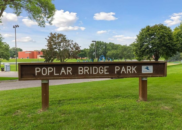 community sign featuring a lawn