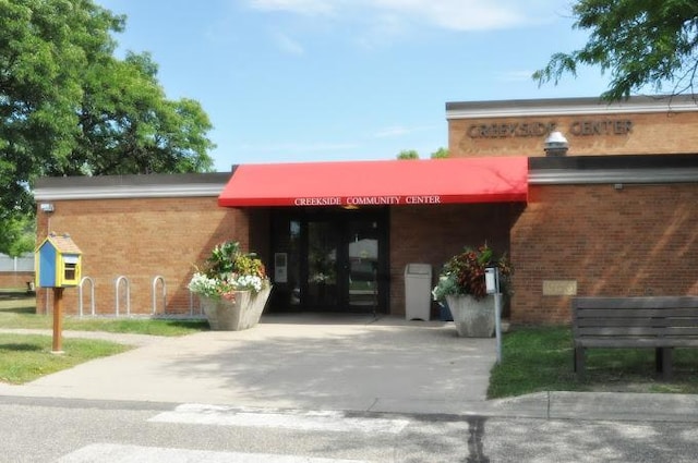view of building exterior featuring driveway and an attached carport