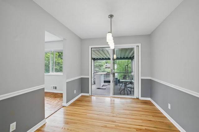 8307 Johnson Ave S, Bloomington, MN 55437 - unfurnished dining area featuring light wood-style floors and baseboards