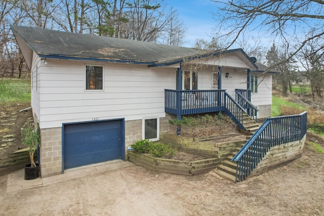 1601 Welland Ave, Minnetonka, MN 55305 - view of front facade with a garage, covered porch, driveway, and stairway