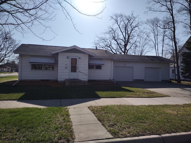 522 6th Ave, Madison, MN 56256 - view of front of home with concrete driveway, a front yard, and a garage