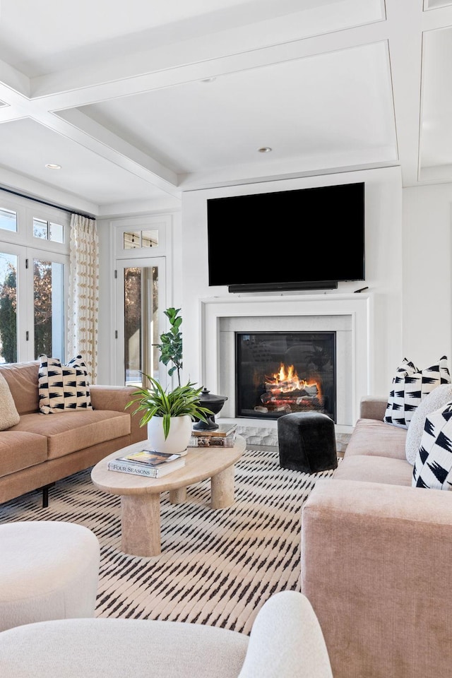 living room featuring a glass covered fireplace, beam ceiling, and french doors