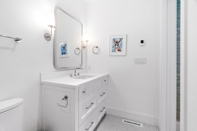 bathroom with vanity, tile patterned flooring, toilet, and baseboards