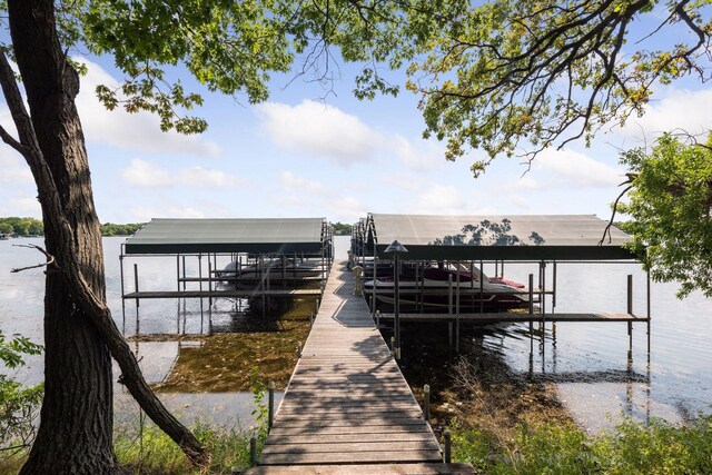 dock area featuring boat lift and a water view