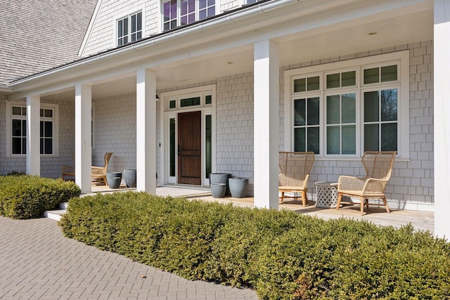 view of exterior entry with covered porch