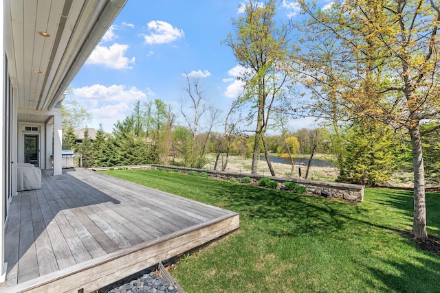 deck featuring a water view and a lawn