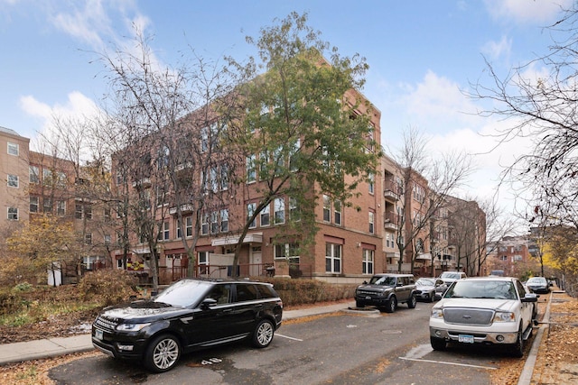 view of building exterior featuring uncovered parking