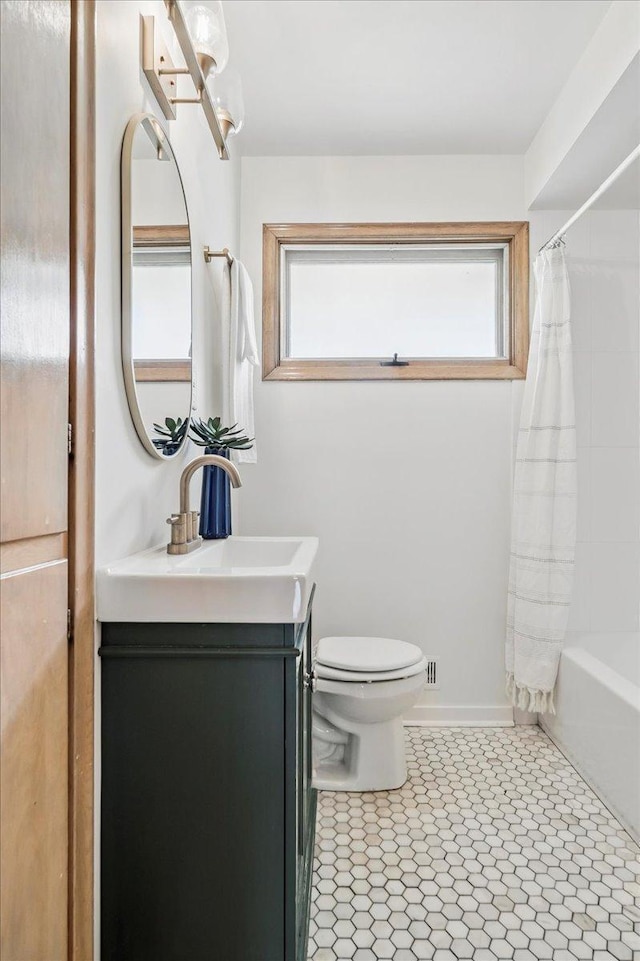 bathroom with vanity, toilet, tile patterned floors, and shower / tub combo