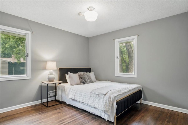 bedroom featuring baseboards and wood finished floors