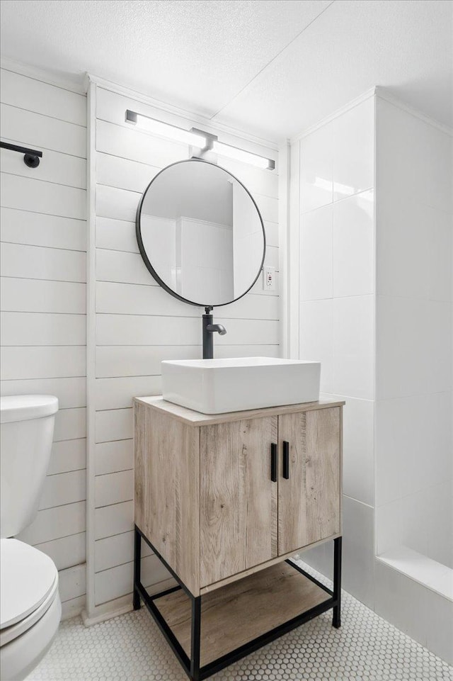 bathroom with toilet, vanity, and a textured ceiling