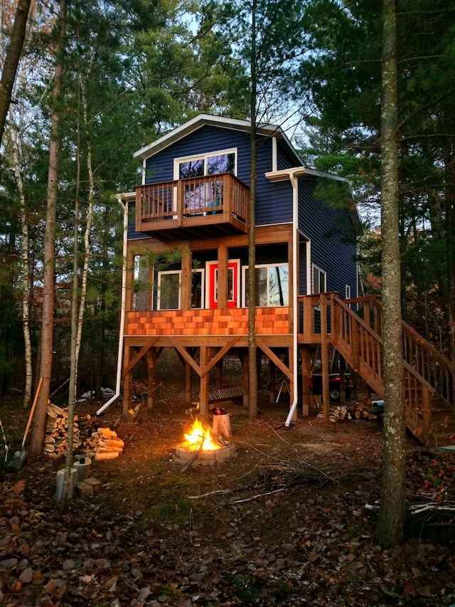 6274 Azalea Rd, Motley Twp, MN 56466 - rear view of property featuring stairs, a fire pit, and a wooden deck
