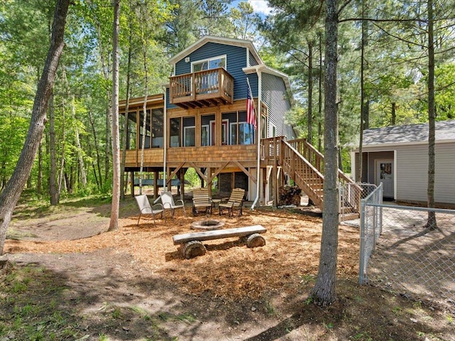 6274 Azalea Rd, Motley Twp, MN 56466 - rear view of house with a sunroom, stairs, and a fire pit