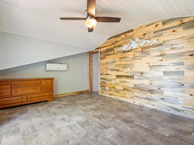 6274 Azalea Rd, Motley Twp, MN 56466 - additional living space with vaulted ceiling, wooden walls, a wall mounted air conditioner, wood finished floors, and a ceiling fan