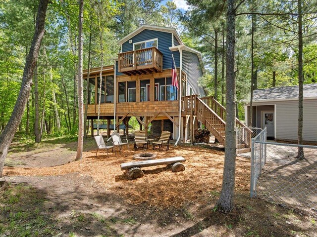 6274 Azalea Rd, Motley Twp, MN 56466 - rear view of house with a sunroom, stairs, and a fire pit