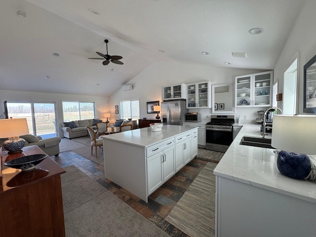 92620 Palon Rd, Sturgeon Lake, MN 55783 - kitchen with a sink, dark wood finished floors, lofted ceiling, a ceiling fan, and appliances with stainless steel finishes