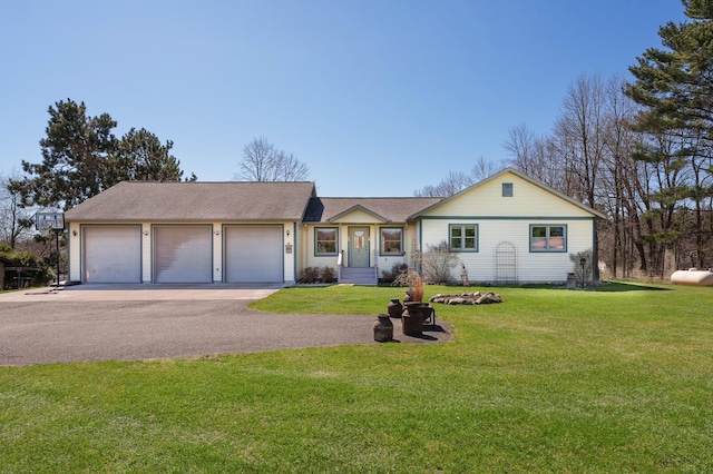 ranch-style home featuring a garage and a front lawn