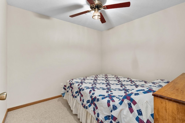 bedroom featuring baseboards, ceiling fan, and light carpet