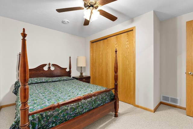 carpeted bedroom with visible vents, a ceiling fan, baseboards, and a closet
