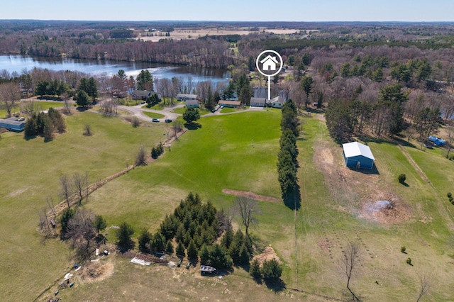 birds eye view of property with a water view and a wooded view