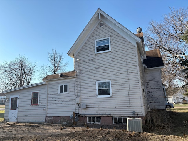 rear view of house with cooling unit
