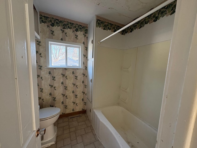 full bathroom with toilet, wallpapered walls, shower / bath combination, visible vents, and brick floor