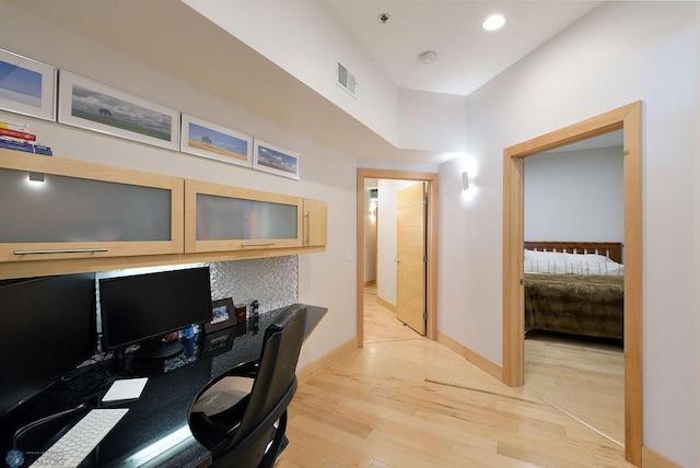 319 Broadway N Unit 202, Fargo, ND 58102 - home office featuring light wood finished floors, baseboards, built in desk, and recessed lighting
