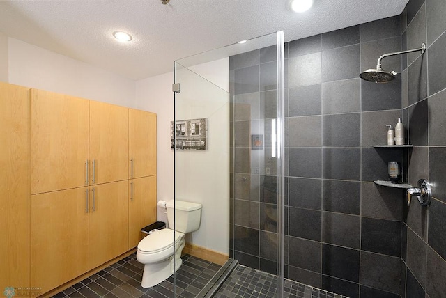 319 Broadway N Unit 202, Fargo, ND 58102 - bathroom featuring a shower stall, toilet, tile patterned floors, a textured ceiling, and recessed lighting
