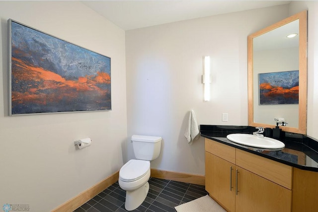 319 Broadway N Unit 202, Fargo, ND 58102 - bathroom with toilet, tile patterned floors, baseboards, and vanity
