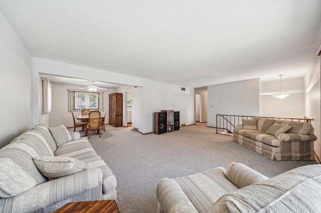 living room with light colored carpet and a ceiling fan