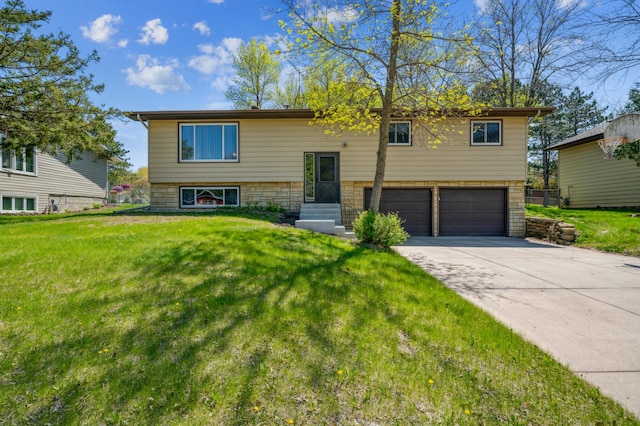 split foyer home with a garage, a front lawn, driveway, and entry steps