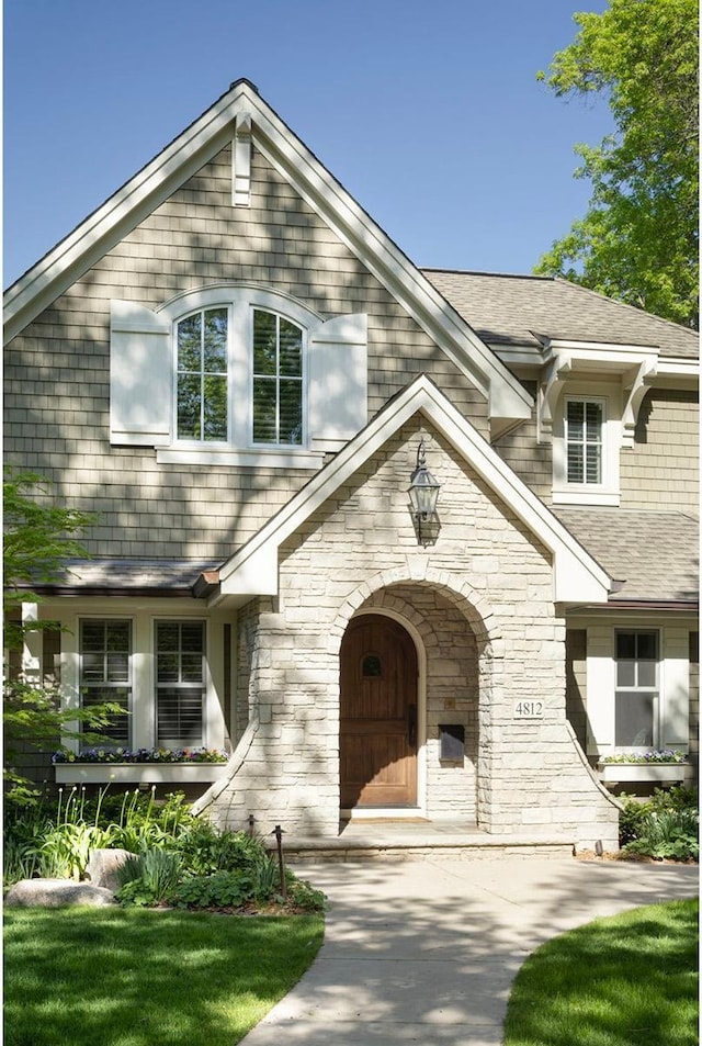 4812 Maple Rd, Edina, MN 55424 - view of front facade featuring stone siding and roof with shingles