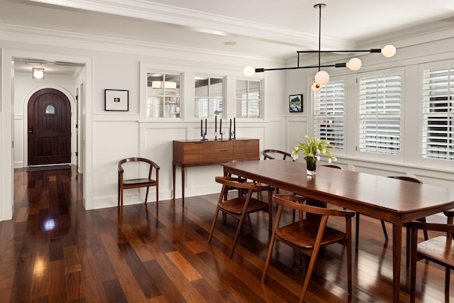 4812 Maple Rd, Edina, MN 55424 - dining room with a decorative wall, wood finished floors, crown molding, a wainscoted wall, and a chandelier