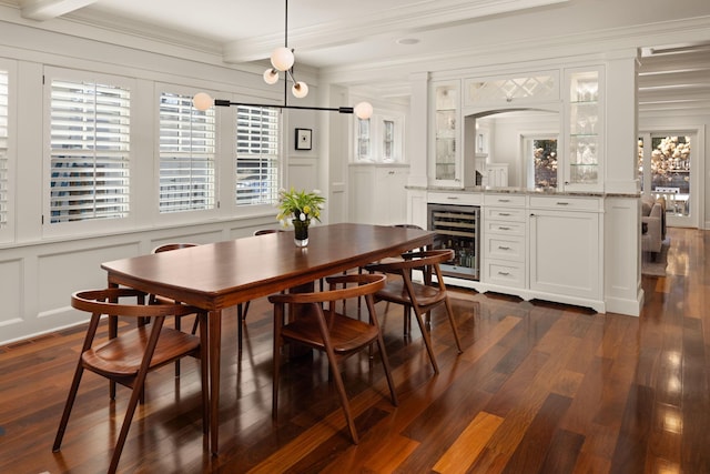 4812 Maple Rd, Edina, MN 55424 - dining room featuring a decorative wall, wine cooler, dark wood finished floors, crown molding, and a dry bar