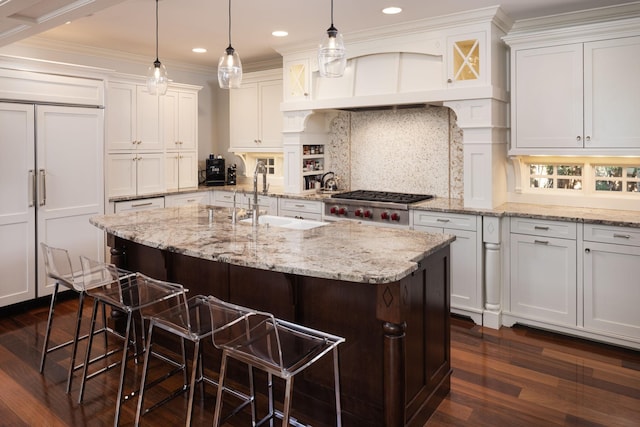 4812 Maple Rd, Edina, MN 55424 - kitchen featuring a sink, dark wood-style flooring, white cabinetry, a kitchen bar, and decorative backsplash