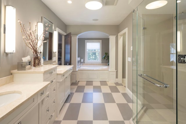 4812 Maple Rd, Edina, MN 55424 - full bath with decorative columns, tile patterned floors, a shower stall, and vanity