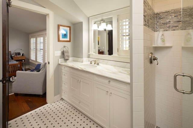 4812 Maple Rd, Edina, MN 55424 - ensuite bathroom with vanity, a stall shower, tile patterned floors, and baseboards