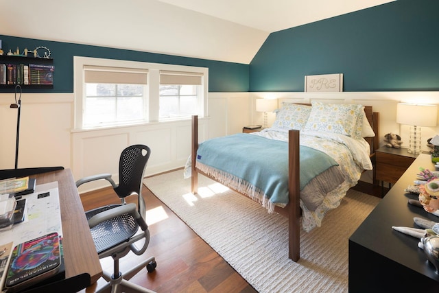4812 Maple Rd, Edina, MN 55424 - bedroom featuring wainscoting, wood finished floors, vaulted ceiling, and a decorative wall