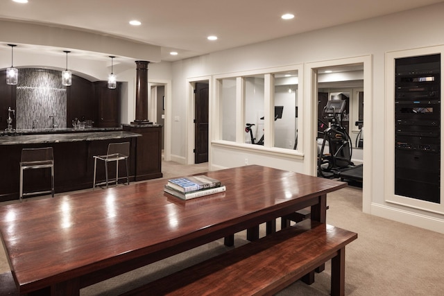 4812 Maple Rd, Edina, MN 55424 - dining area featuring recessed lighting, light carpet, ornate columns, baseboards, and bar with sink