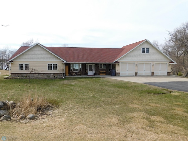 ranch-style home featuring a garage, a front lawn, stone siding, and driveway
