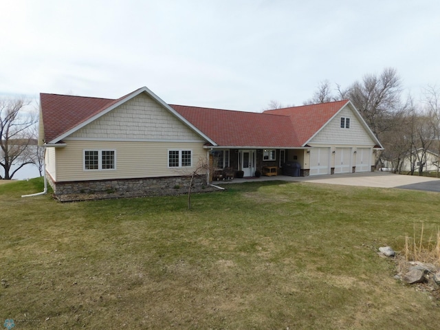 view of front of property with a front lawn, a shingled roof, driveway, and a garage