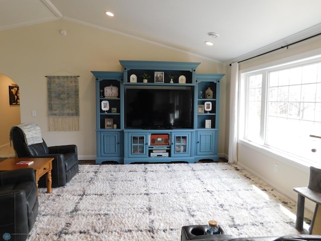 living room featuring vaulted ceiling, baseboards, arched walkways, and recessed lighting