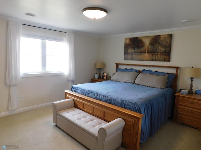 bedroom with light colored carpet, crown molding, and baseboards