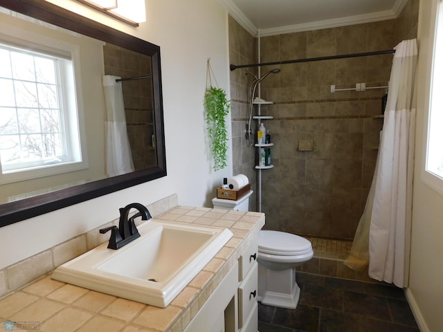 bathroom with crown molding, vanity, toilet, and tiled shower