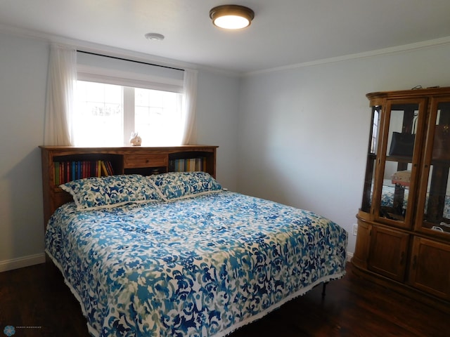 bedroom featuring baseboards, dark wood-style flooring, and ornamental molding